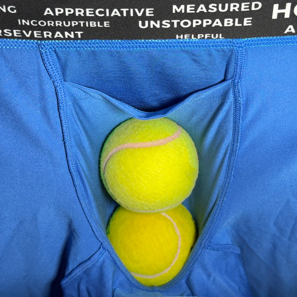 Two yellow tennis balls inside a blue bag with motivational text on a black background.