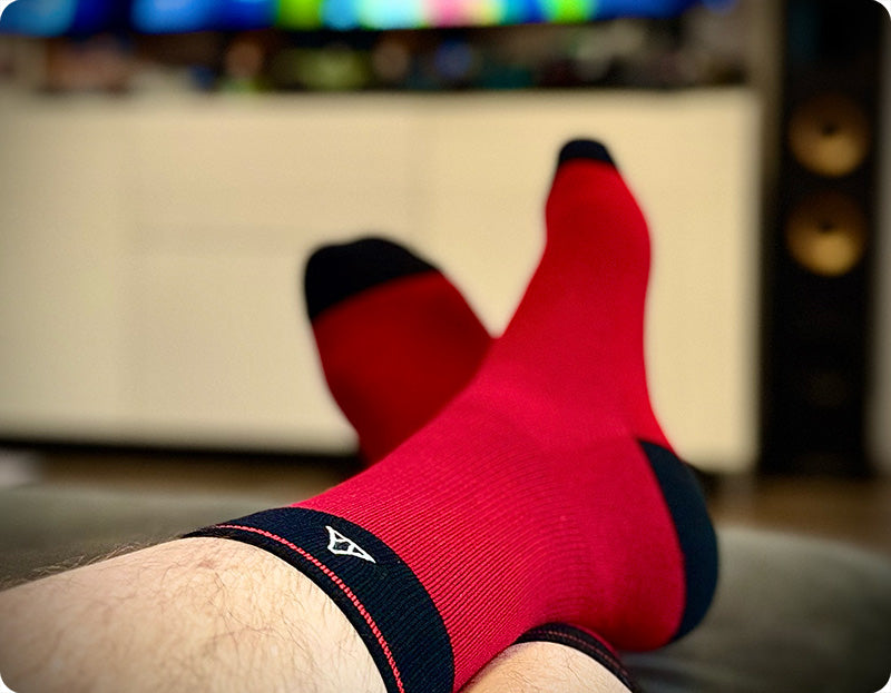 Socks shown on a pair of feet in red.