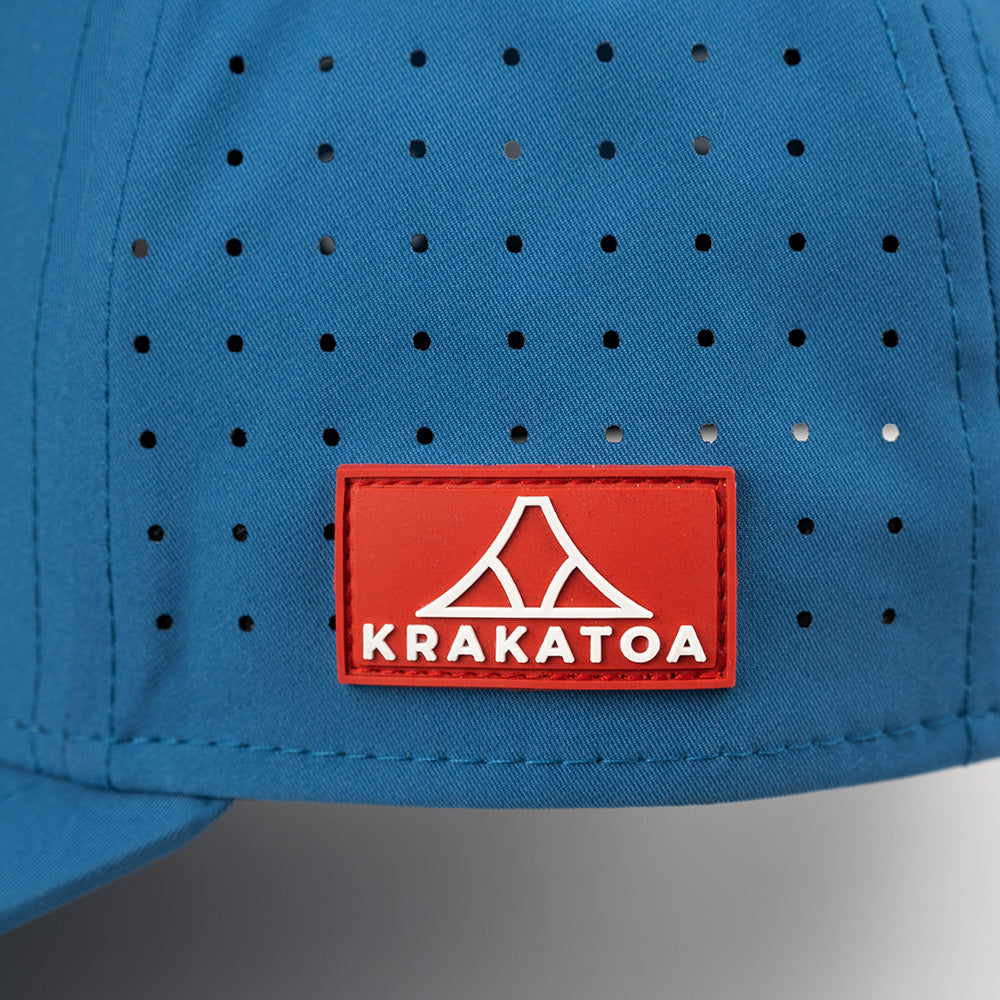 Blue cap with a red Krakatoa logo patch on a gray background