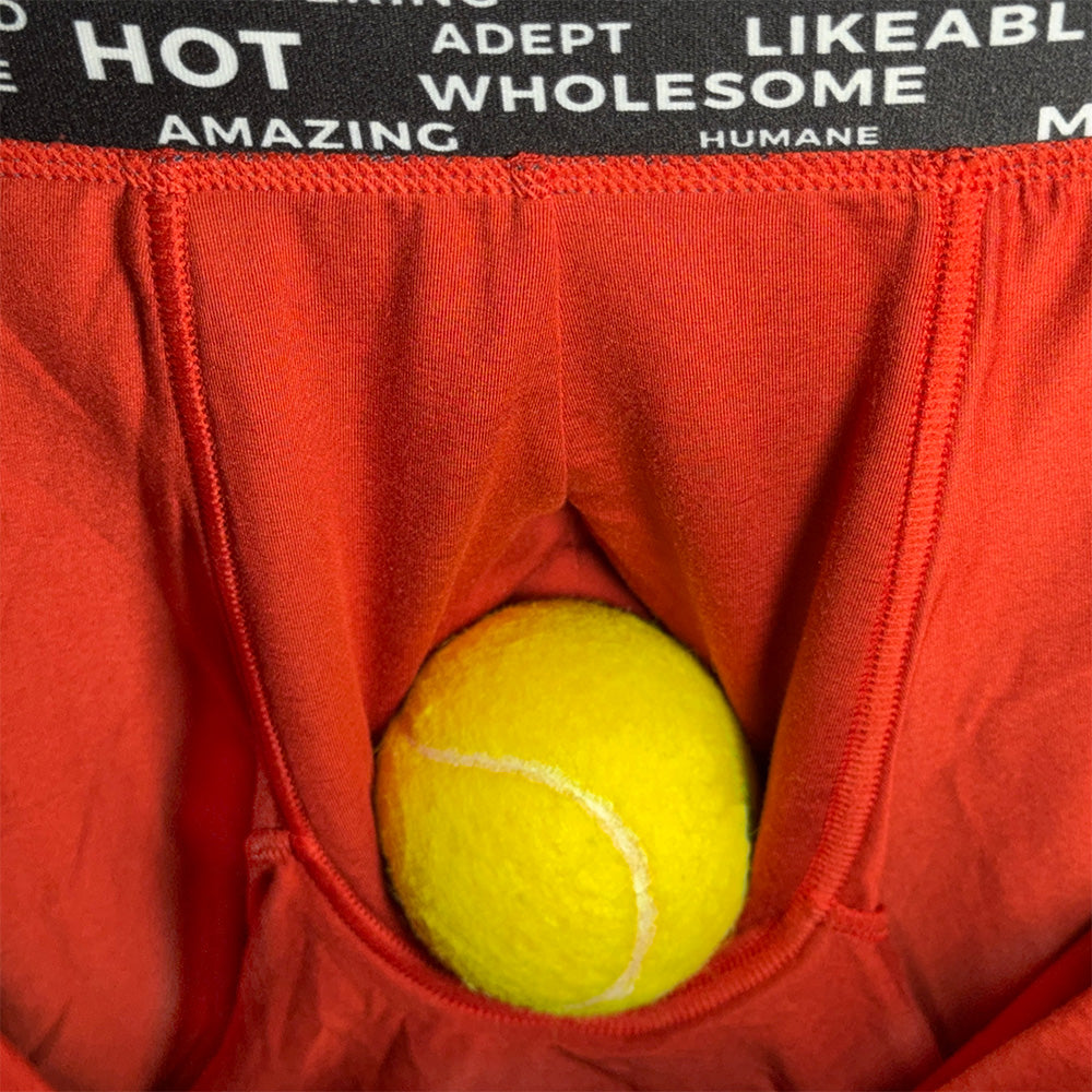 Red underwear with a yellow tennis ball inside, black waistband with white text.