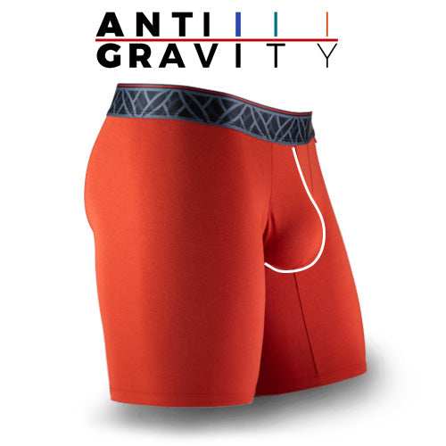 Red athletic shorts with a black waistband on a white background, featuring the 'ANTI GRAVITY' brand.