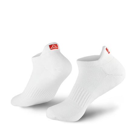 White no-show socks with red Krakatoa logo on the back flap, on a white background